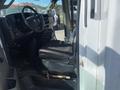 Interior view of a 2020 Chevrolet Express with a driver's seat visible and dashboard controls nearby