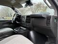 Interior view of a 2021 Chevrolet Express showing the driver’s seat dashboard and controls with multi-function display and air vents