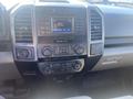 Dashboard of a 2017 Ford F-150 featuring a touchscreen display radio navigation controls and climate control buttons