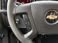 A close-up view of the steering wheel and control buttons of a 2019 Chevrolet Express with the Chevrolet logo visible