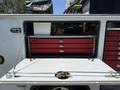 A 2020 Ram 2500 truck with an open tool compartment showcasing red drawers and a power tool visible inside