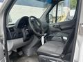 Interior of a 2010 Mercedes-Benz Sprinter featuring a driver's seat steering wheel and dashboard with controls
