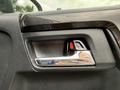 Close-up of the interior door handle of a 2021 Toyota 4Runner featuring a sleek chrome design and a red safety release button