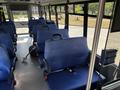 Interior of a 2020 Chevrolet Express featuring blue upholstered seats with seatbelts and a clean layout