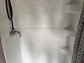 Interior shower in a 2021 Jayco Jay Flight featuring a handheld showerhead and textured wall with built-in shelves