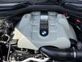 A 2004 BMW 6-Series engine with a silver cover and a prominent BMW logo visible on the top
