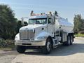 White 2008 Peterbilt 340 truck with a large tank trailer and chrome details parked on a driveway