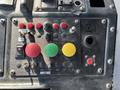 Control panel of a 2011 Autocar Xpeditor featuring various buttons in red green yellow and black with labeled switches and indicators