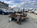 A 2013 JLG Industries Flat Deck Trailer with a large flat loading surface and multiple attachment points for cargo storage and transportation