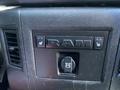 A control panel from a 2017 RAM 1500 featuring buttons for heated seats and a 12V DC power outlet