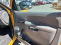 Interior door panel of a 2013 Chevrolet Silverado 1500 featuring a handle and cup holders with a textured gray surface