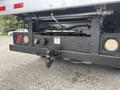 A 2014 Ford F-550 rear view featuring a tow hitch and towing equipment with various lights and connections visible