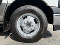 A close-up of a silver alloy wheel mounted on a black tire with the branding visible on the sidewall