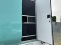 A 2020 Freightliner MT45 with an open side door revealing a black mesh screen and interior space behind it