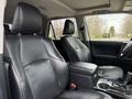 Interior view of a 2021 Toyota 4Runner featuring black leather seats and a center console