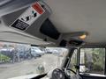 Interior view of a 2012 International DuraStar 4300 truck showing the dashboard and overhead controls with warning labels