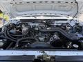 Engine compartment of a 1995 Ford F-250 featuring various components like the engine block wiring and hoses