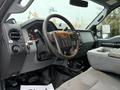 Interior of a 2015 Ford F-450 featuring a dashboard with gauges and controls along with a gray fabric seat and center console