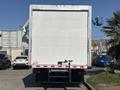 A white 2018 Hino 195 delivery truck viewed from the rear with a plain cargo box and visible tow hitch