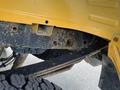 A close-up view of the undercarriage of a 2017 Ford F-250 SD showing a dirty metal frame and a tire visible through the space beneath the truck