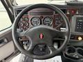 Interior view of a 2008 Kenworth T370 dashboard featuring a steering wheel gauges and control buttons