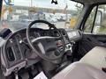 Interior view of a 2013 Freightliner 114SD truck featuring a driver's seat steering wheel and dashboard with various controls and gauges