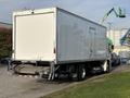 A white 2022 Lion Lion6 truck with a boxy cargo area and a partial view of a loading dock in the background