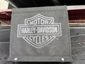 A black fabric banner featuring the Harley-Davidson logo with the words Motor and Cycles prominently displayed in a bold design