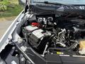 Close-up of the engine compartment of a 2021 Ford F-150 highlighting the battery and various engine components