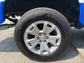 Close-up of a silver wheel with a Chevrolet logo and Advantage tire on a 2017 Chevrolet Colorado