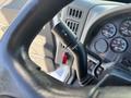A close-up of the steering column in a 2013 International 7500 featuring the turn signal and wiper control stalks