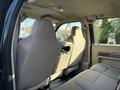 Interior of a 2008 Ford F-550 showing two front seats and the back of the driver's seat with fabric upholstery