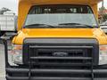 Front view of a yellow 2021 Ford Econoline van with a black grille and headlights
