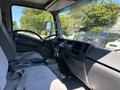 Interior view of a 2016 Isuzu NPR-HD showing the driver's seat dashboard and steering wheel