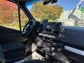 Interior view of a 2021 Mercedes-Benz Sprinter 2500 featuring a steering wheel dashboard and control panel with air vents and storage compartments