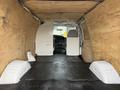 Interior of a 2008 Ford Econoline with a spacious cargo area featuring wooden paneling and rubber flooring