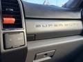 Close-up of the dashboard of a 2020 Ford F-350 featuring the embossed Super Duty lettering and controls for AC and power outlets