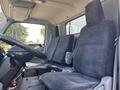 Interior of a 2018 Hino 195 showing two cloth seats in the cabin with a steering wheel and dashboard visible