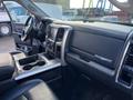 Interior view of a 2017 RAM 1500 showcasing the dashboard steering wheel and center console with cup holders