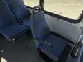 Interior view of a 2017 Chevrolet Express showing blue upholstered seating and a single driver's seat with armrest