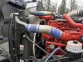 Close-up of a 2018 Kenworth T800 truck engine showing the blue hoses and engine components in red and black colors