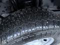 Close-up of a rugged tire tread of a 2023 Ford F-250 showcasing deep grooves and a strong grip designed for off-road terrain