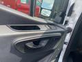 Interior door panel of a 2025 Mercedes-Benz Sprinter featuring controls for windows and locks
