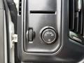 The control panel of a 2016 GMC Sierra 1500 featuring a dial for automatic headlights and a knob for adjusting brightness