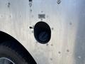 A close-up of a fuel filler cap on a silver 2008 Workhorse W62 revealing the circular opening and a tethered cap