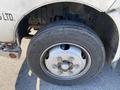 Close-up of a 2014 Hino 195 truck wheel and tire showing the tire tread and metal rim
