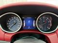 Dashboard of a 2016 Maserati Ghibli displaying speedometer and tachometer with digital information screen showing kilometers and temperature