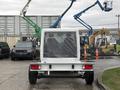 A 2023 RAM Promaster 3500 chassis cab viewed from the rear with a flatbed design and no cargo or body mounted on it
