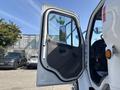 A 2014 Freightliner M2 106 truck door open showing the interior and driver's seat