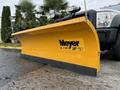 A yellow Meyer snow plow attachment designed for a truck with a wide blade and a sturdy structure mounted on a Ford F-450 SD